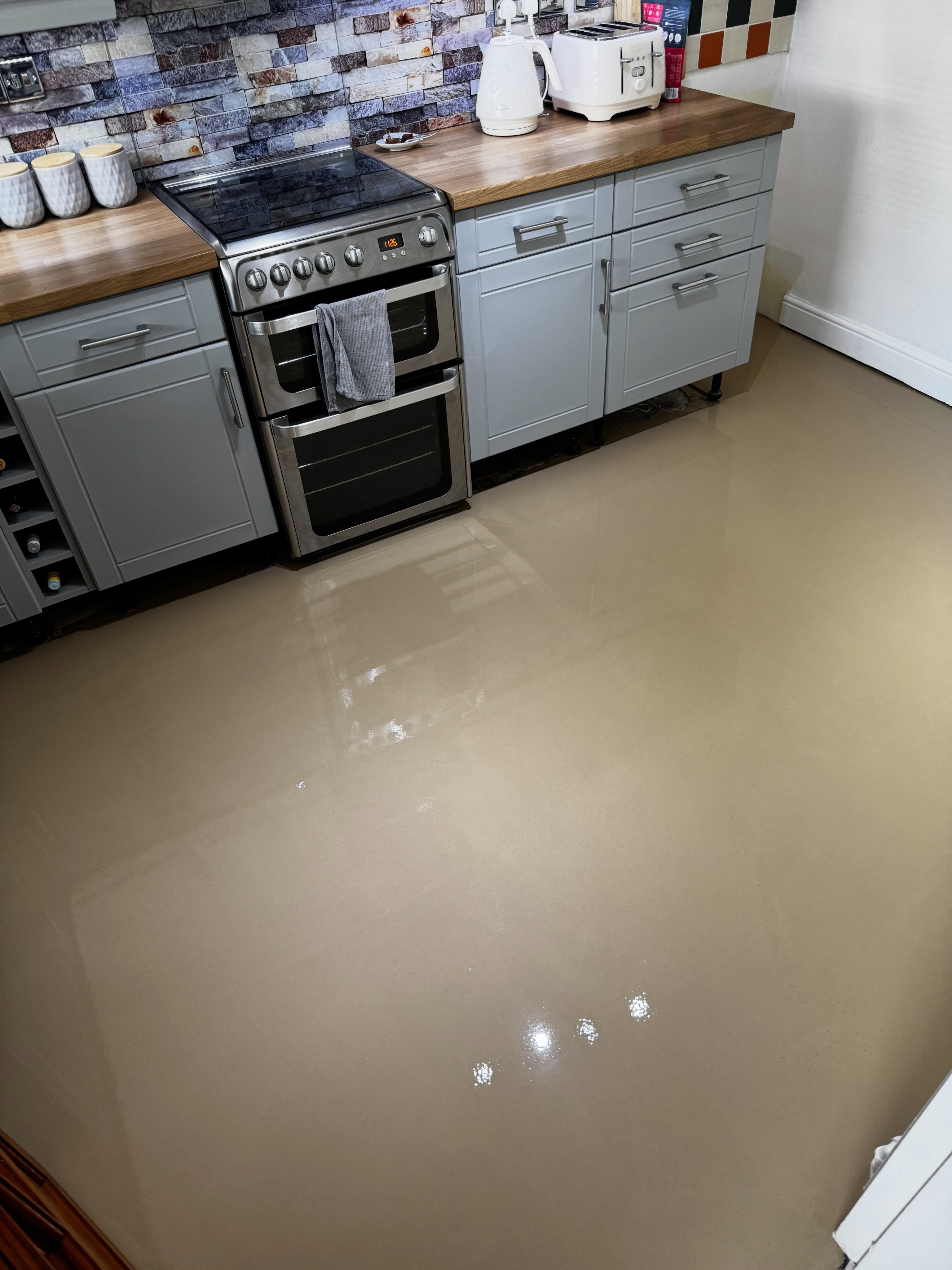 Liquid self-levelling screed poured in a kitchen